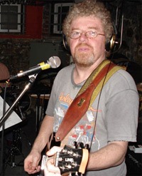 Jim Armstrong playing a guitar