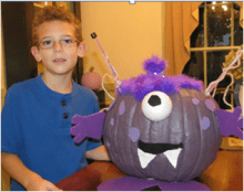 Boy with pumpkin Boy with cyclon decorated purple pumpkin