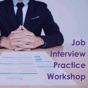 Employment Workshop Images A torso of a person in a suit, sitting hands folded across a desk with a resume in front of them