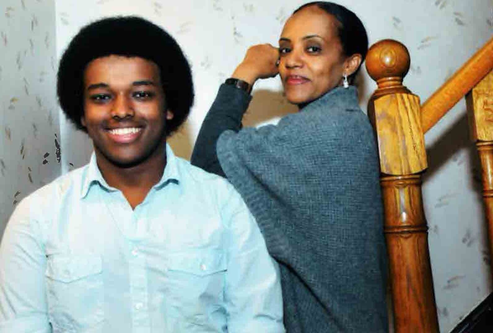 Anna and her Son Nebyu posing for a photo together, standing on a staircase