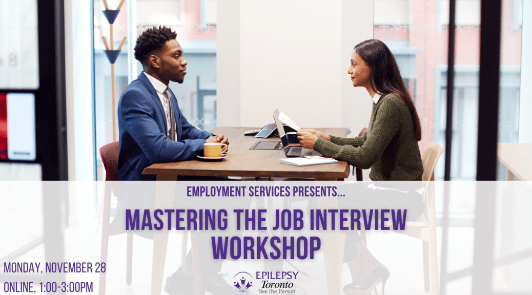 gentleman in a suit seated at an interview with another woman