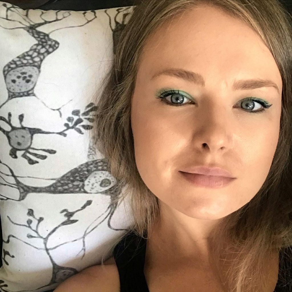 Nikki, Young women story with Epilepsy, Nikki laying neuron pillow, Epilepsy Toronto.